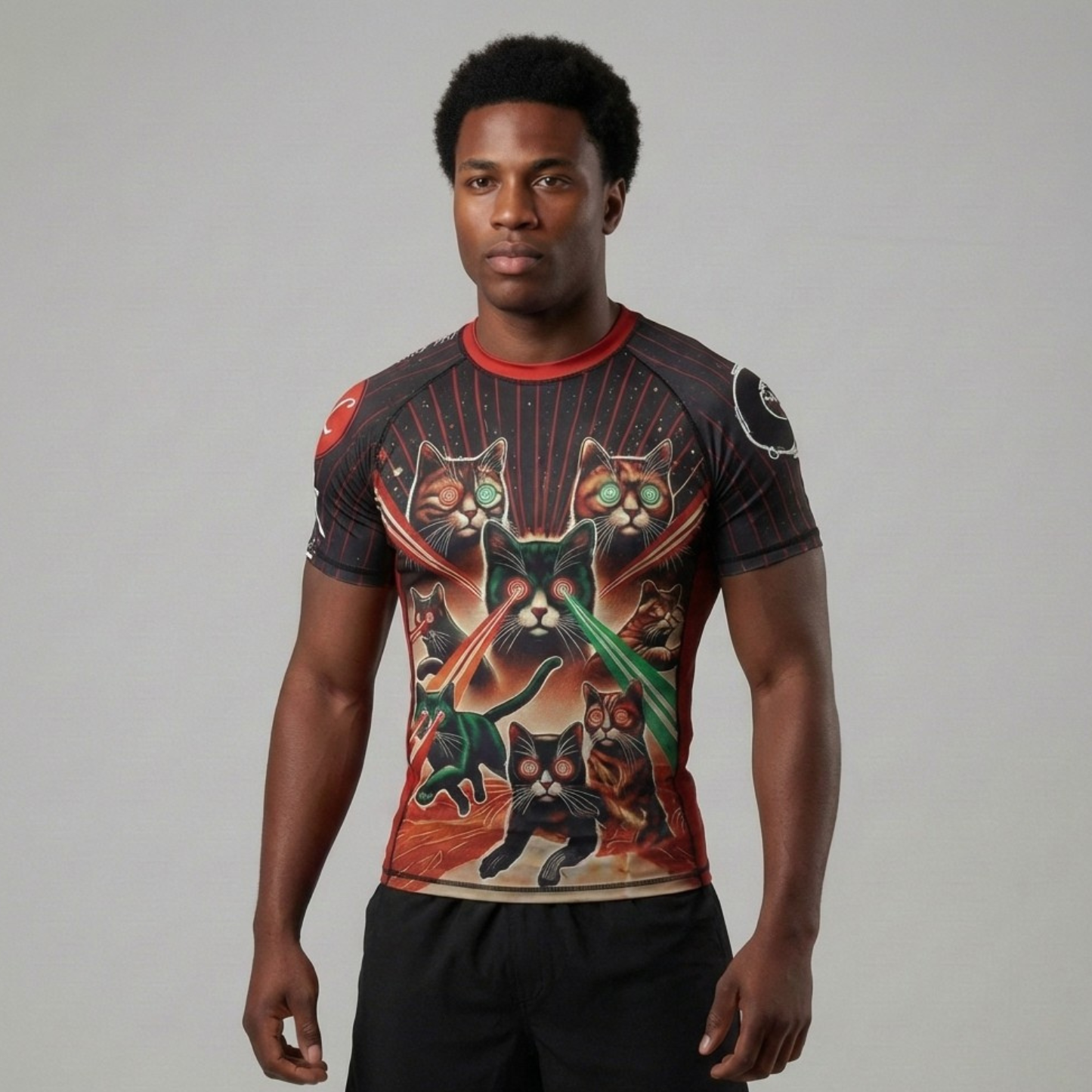 Person wearing a graphic BJJ rash guard with cat designs on a plain background