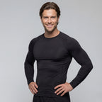 Man wearing a black long-sleeve BJJ rash guard on a gray background