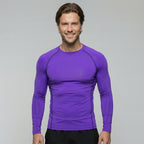 Man wearing a purple long-sleeve athletic shirt on a gray background