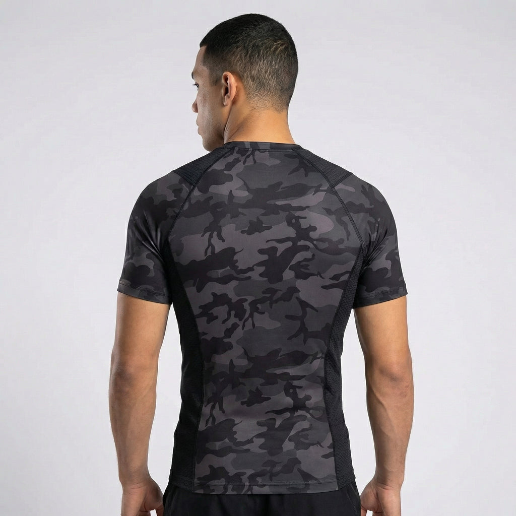 Person wearing a black camouflage athletic shirt on a white background