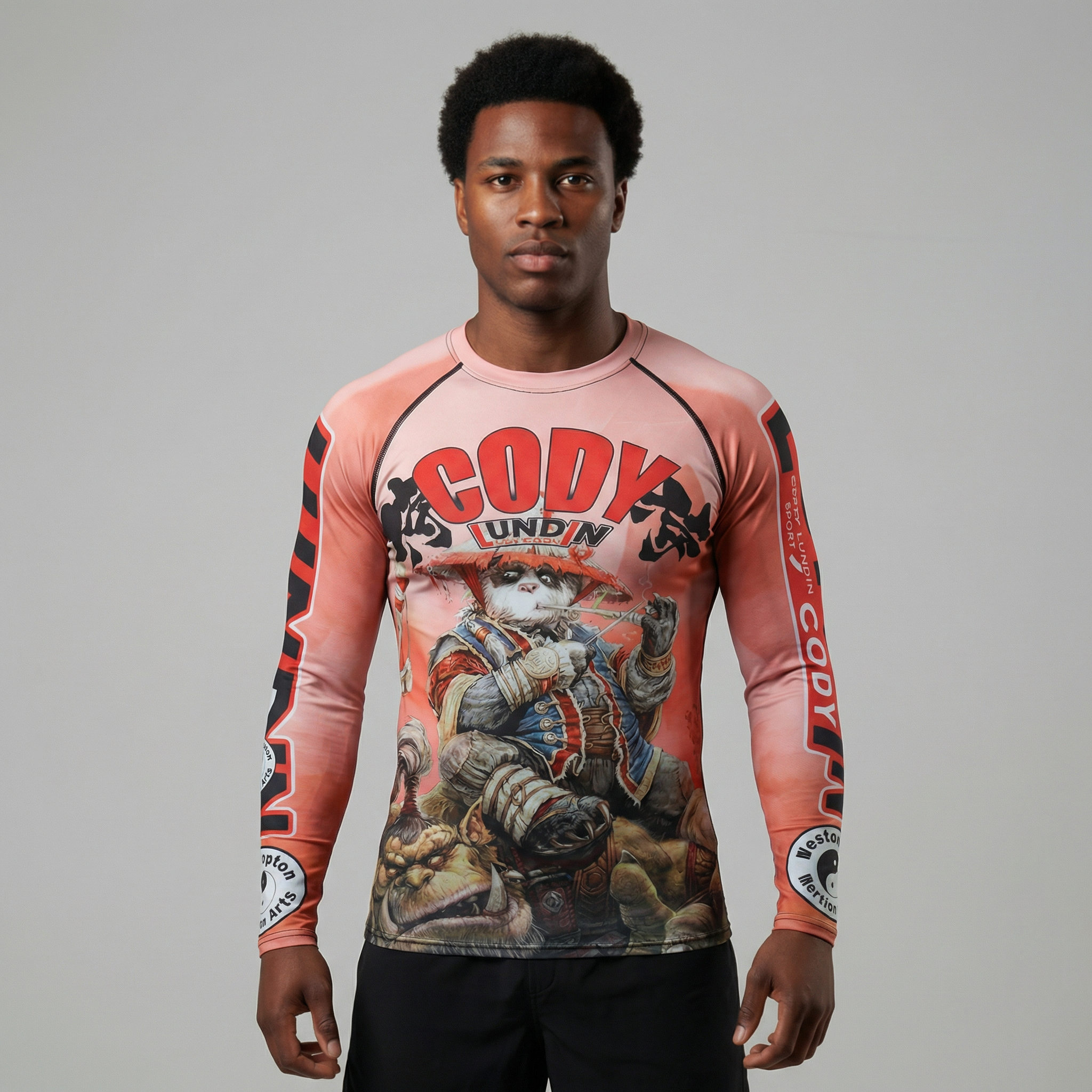 Person wearing a long-sleeve BJJ Rash guard with graphic design and text on a gray background