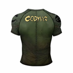 Green BJJ rash guard with branding on a white background